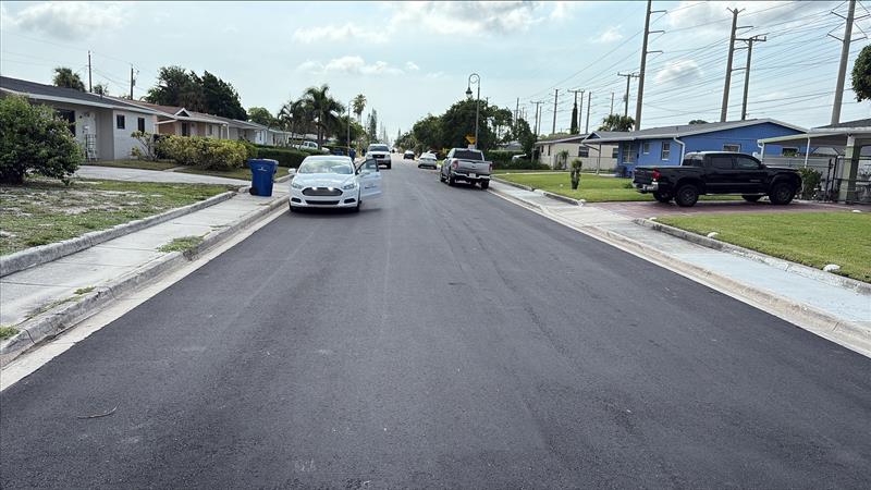 Roadway paving underway on one side of a residential street